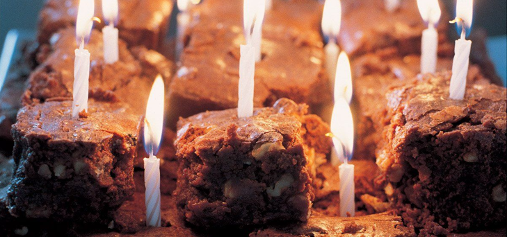 brownies on a plate with candles in them