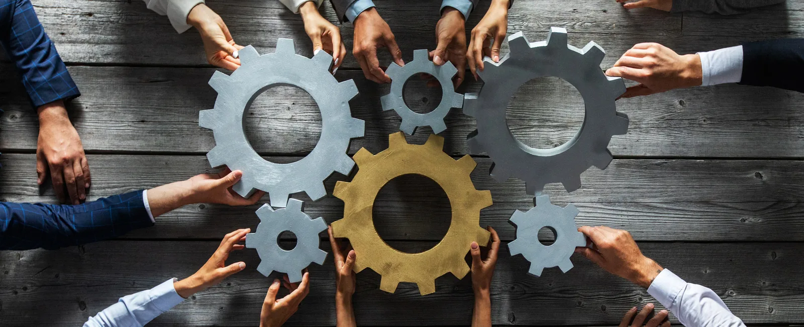 people with gears fitting together